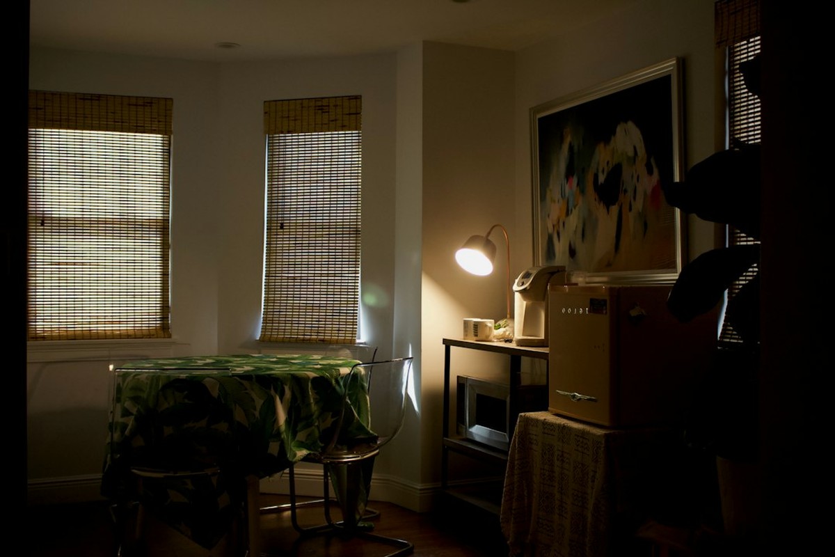 Table with props, folders and a locked case under a single warm lamp in an event room