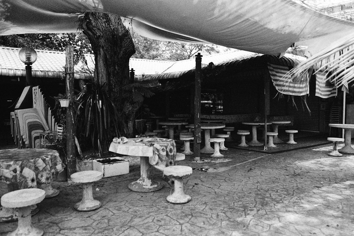 Picnic area with a craft tent, bunting and adult guests at a station table