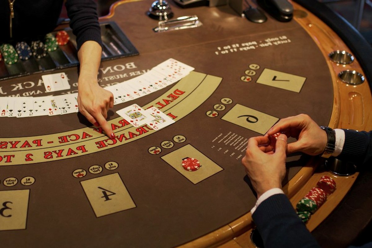 Dressed roulette and blackjack tables in casino styling with a host-croupier and adult guests